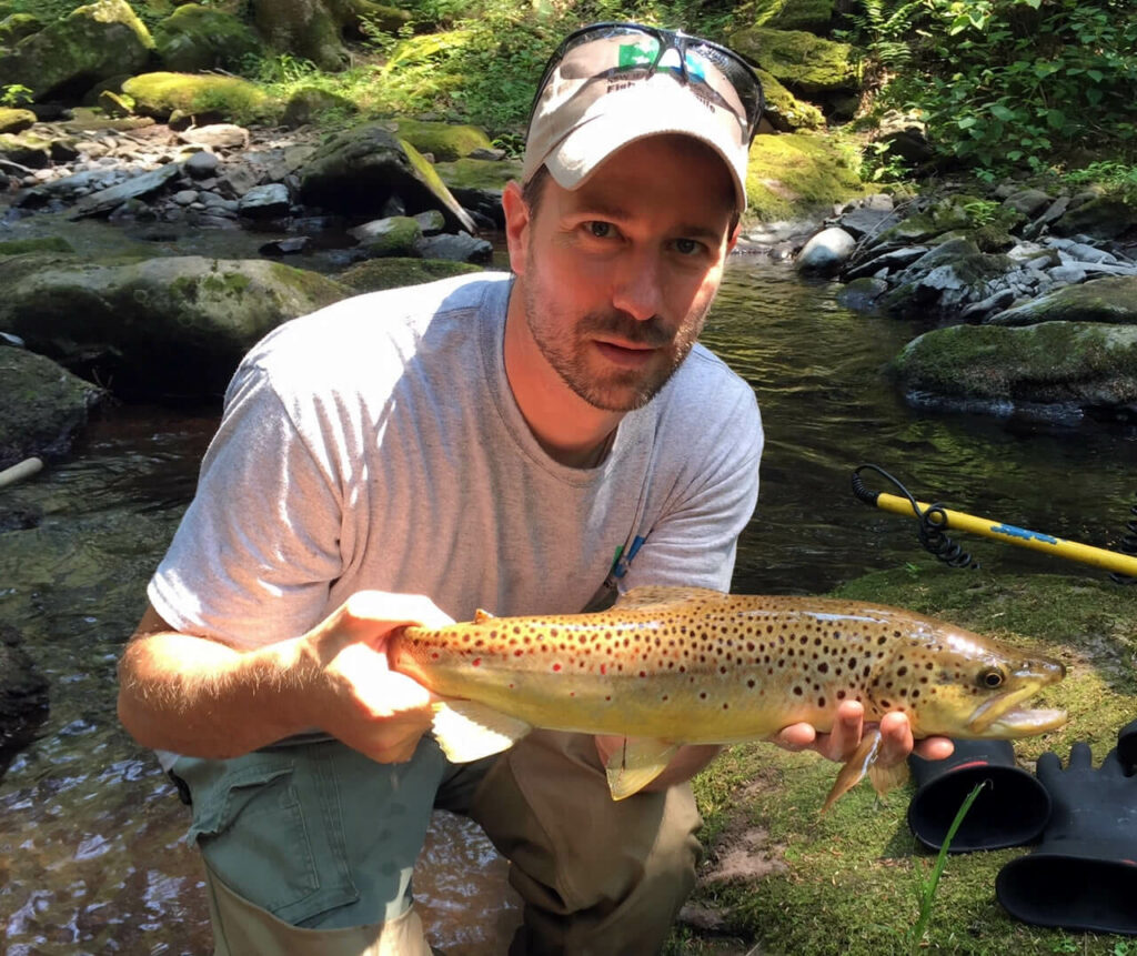 Biologist with wild brown trout