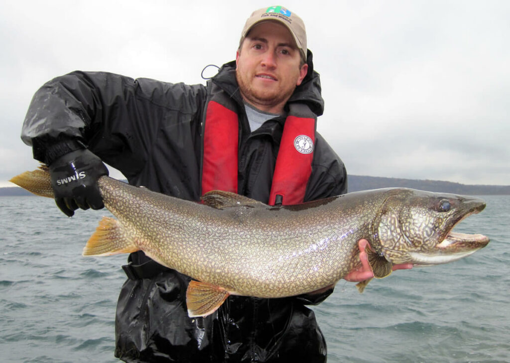 Biologist with large Lake Trout