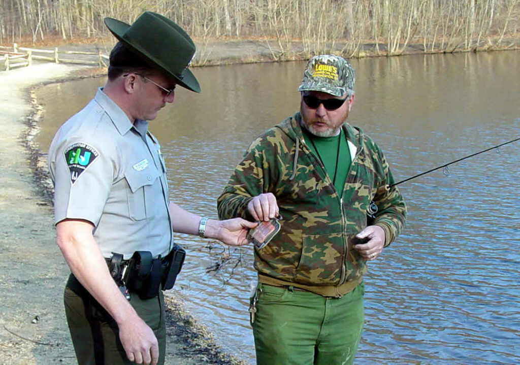 Officer field checks an angler
