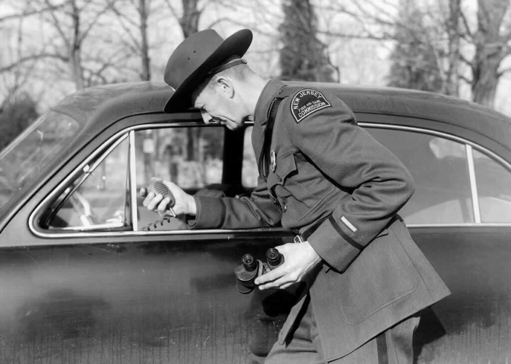 Warden uses an early car radio