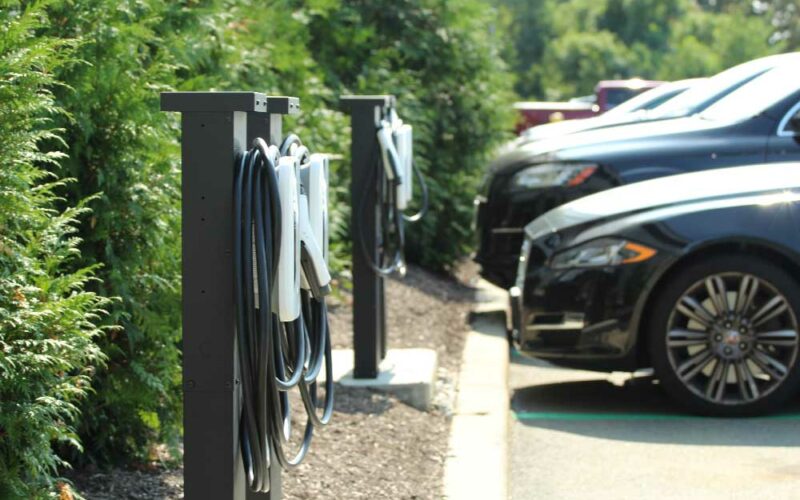 Photo of a line of charging stations and vehicles
