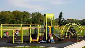 Children playing on a playground Description automatically generated with low confidence