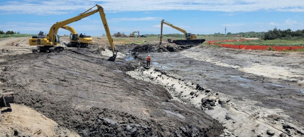 Picture24-june Excavated wetland material placed over stone near the mouth of Pond Creek – June 2024