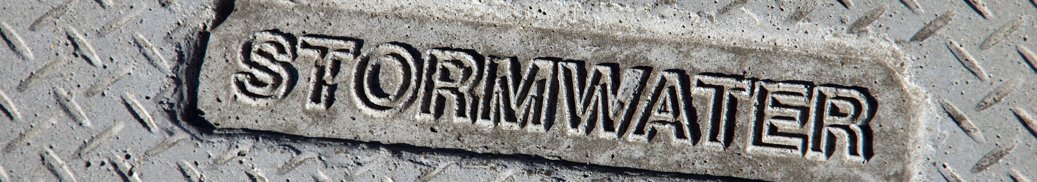 Concrete manhole cover over a stormwater drain